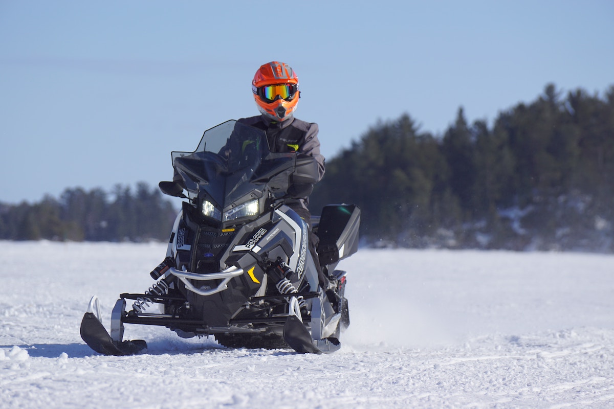 Snowmobile rider on a frozen lake.